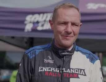 - On the other side, elements hinting at his rally career (e.g., a blurred rally car, desert landscape, dust, or a helmet).